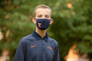 Evan, pictured on the quad wearing a mask 