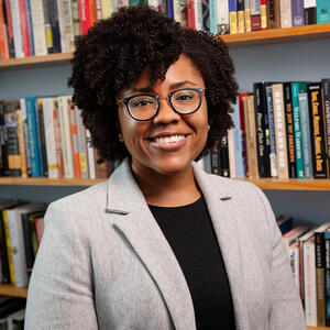 Professor Marsha Barrett infront of bookcase