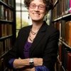 Professor Leslie Reagan, standing in her office. 2 book-cases in the background 